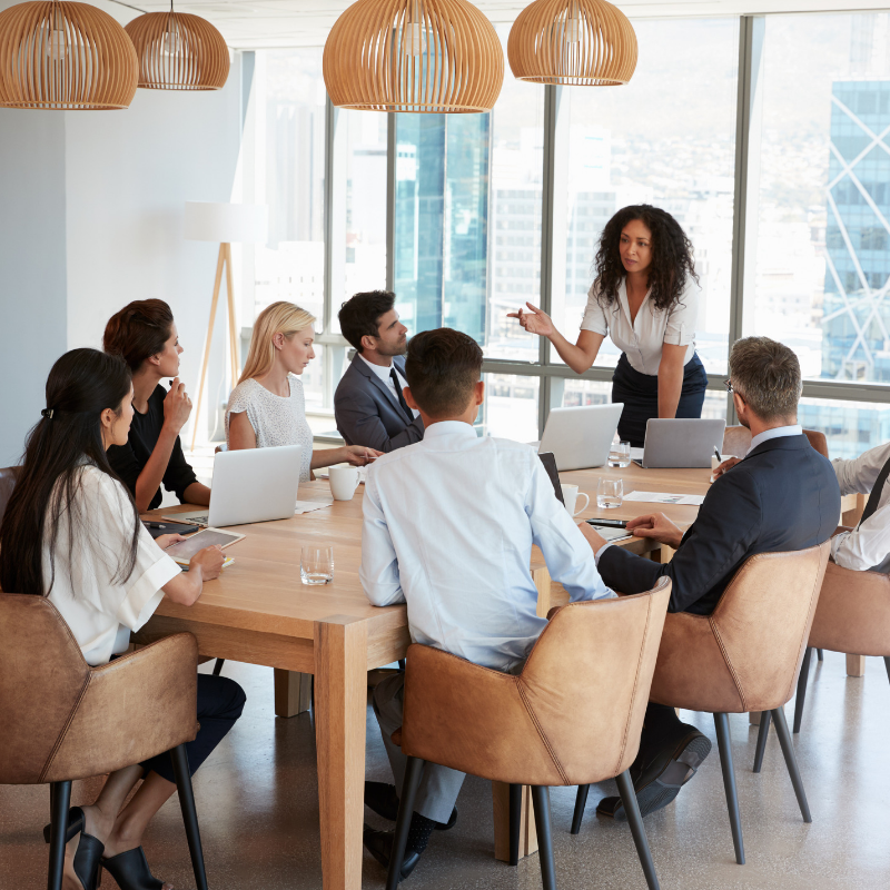 Boardroom meeting featuring several team members 