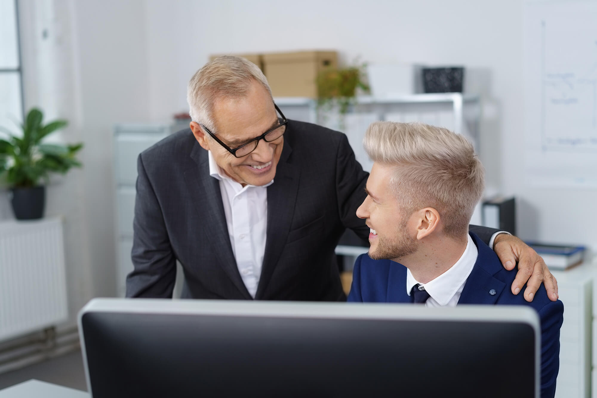 Father and son sat in front of screen inheritance tax planning